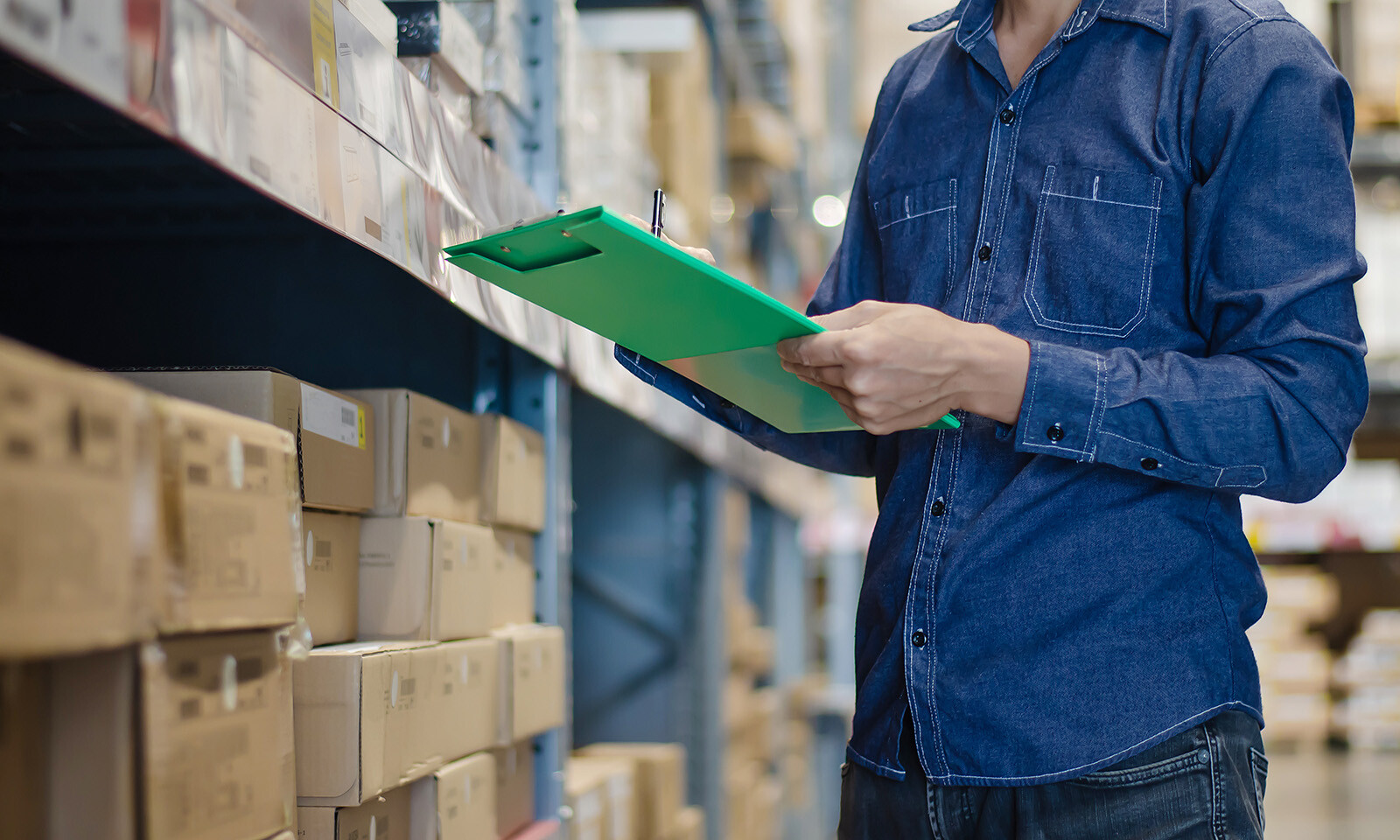 A man taking inventory in a warehouse